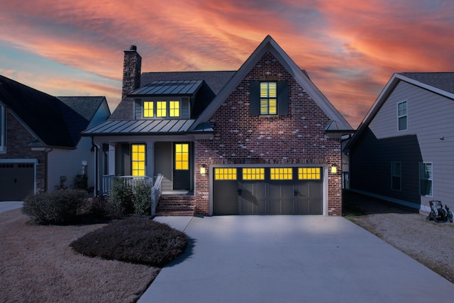 view of front of house featuring a porch and a garage