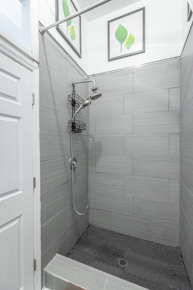 bathroom with a tile shower