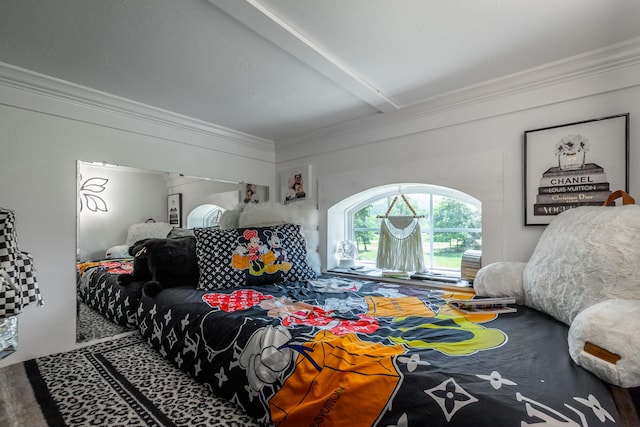 carpeted bedroom featuring beam ceiling and ornamental molding