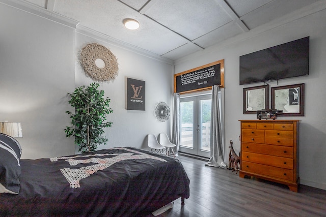 bedroom with dark hardwood / wood-style flooring, access to exterior, crown molding, and french doors