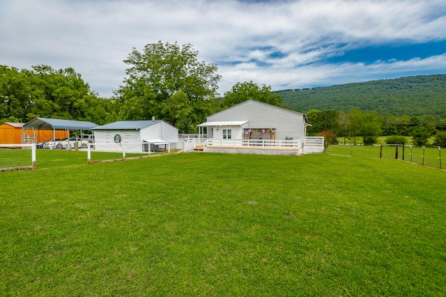 view of yard with a mountain view, a rural view, and a carport