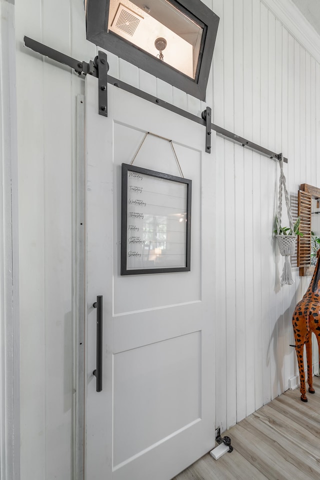 room details featuring wood walls and hardwood / wood-style flooring