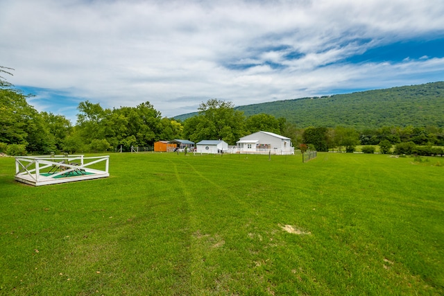 view of yard with a mountain view and a rural view