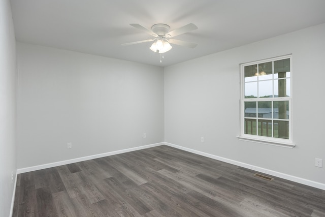 spare room with dark hardwood / wood-style floors and ceiling fan