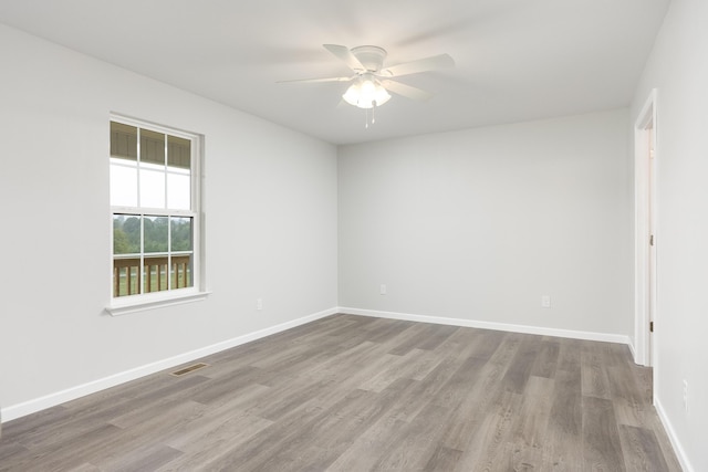 empty room with ceiling fan and wood-type flooring