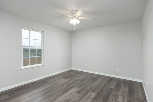 unfurnished room featuring ceiling fan and dark hardwood / wood-style flooring