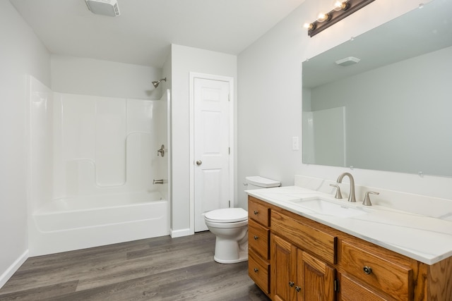 full bathroom with hardwood / wood-style floors, vanity, toilet, and washtub / shower combination