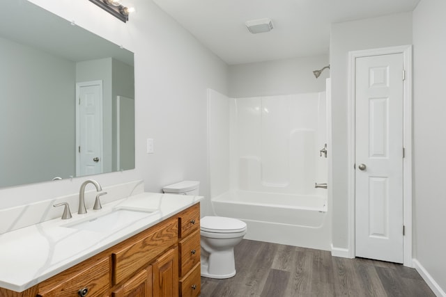 full bathroom featuring hardwood / wood-style flooring, vanity, toilet, and bathtub / shower combination