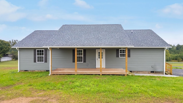 rear view of house featuring a lawn