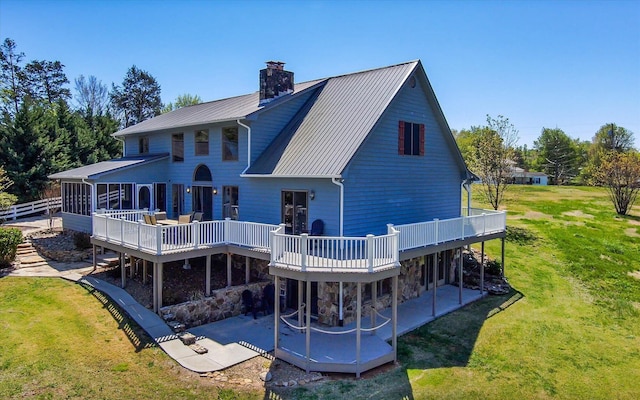 131 Corntassel Shrs, Vonore, TN 37885 - back of house featuring a yard, a wooden deck, a patio, and a chimney