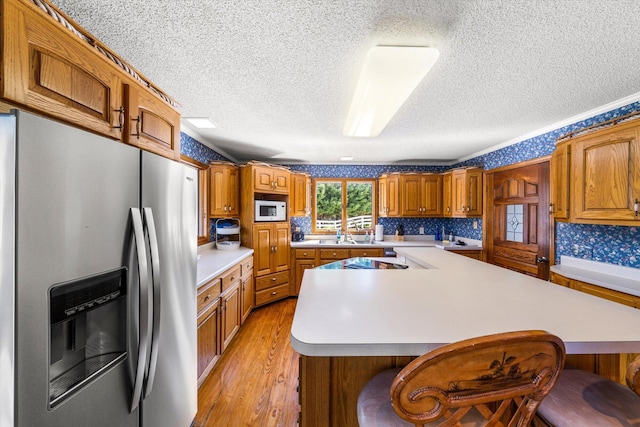 131 Corntassel Shrs, Vonore, TN 37885 - kitchen featuring white microwave, light countertops, stainless steel refrigerator with ice dispenser, brown cabinets, and light wood finished floors