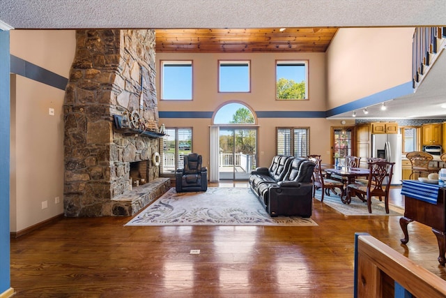 131 Corntassel Shrs, Vonore, TN 37885 - living area featuring a fireplace, baseboards, hardwood / wood-style floors, and wood ceiling