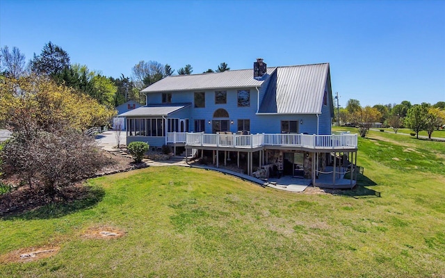 131 Corntassel Shrs, Vonore, TN 37885 - rear view of property featuring a yard, a wooden deck, a sunroom, and a chimney