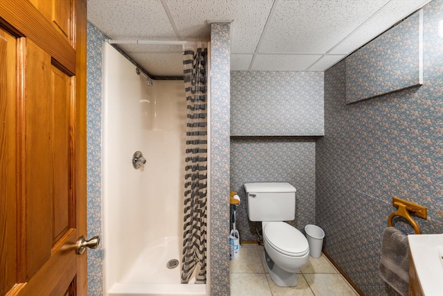 131 Corntassel Shrs, Vonore, TN 37885 - full bath featuring a paneled ceiling, wallpapered walls, a stall shower, tile patterned flooring, and toilet