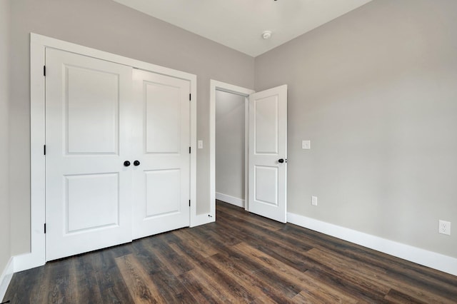 523 13th St SE, Cleveland, TN 37311 - unfurnished bedroom with dark wood-style flooring, a closet, and baseboards