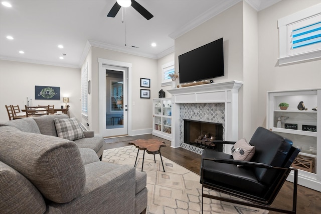 living area featuring recessed lighting, ornamental molding, ceiling fan, and wood finished floors