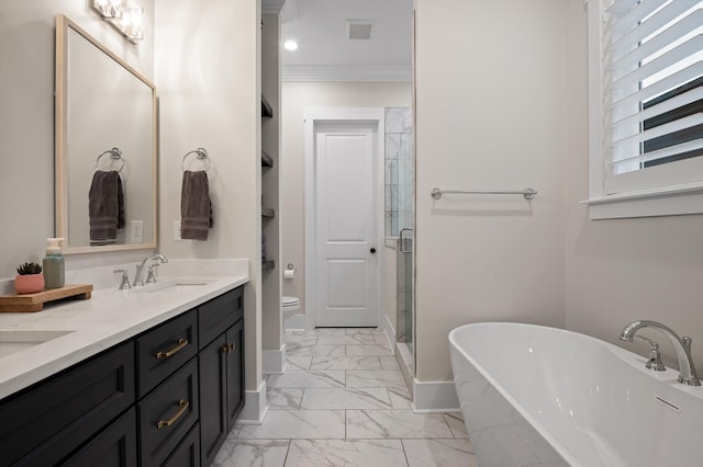 bathroom featuring double vanity, marble finish floor, toilet, a shower stall, and a sink