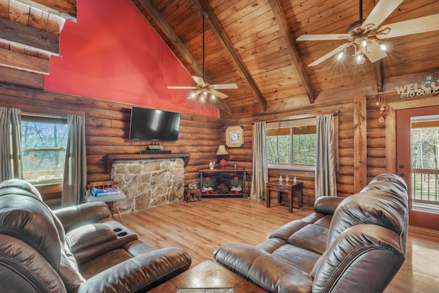 living room featuring log walls, light hardwood / wood-style floors, high vaulted ceiling, and a healthy amount of sunlight