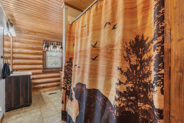 bathroom with wooden ceiling and rustic walls