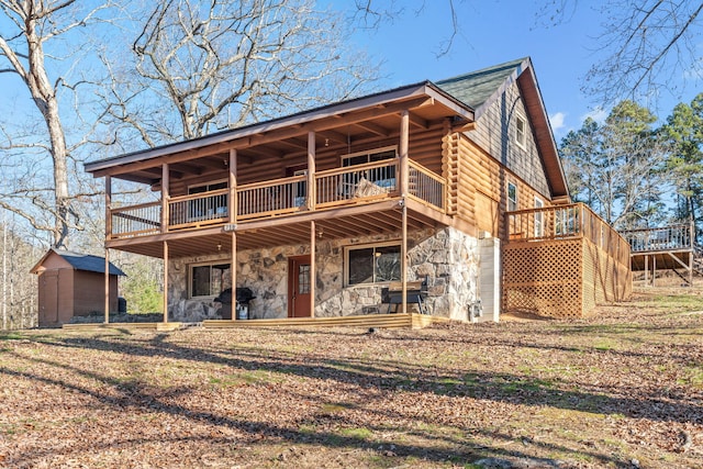 back of house featuring a storage unit