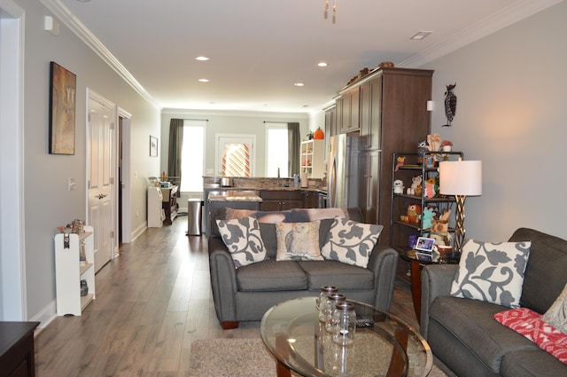 living room featuring hardwood / wood-style floors and ornamental molding