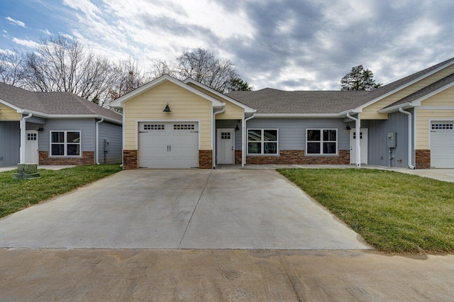 view of front of house with a garage and a front lawn