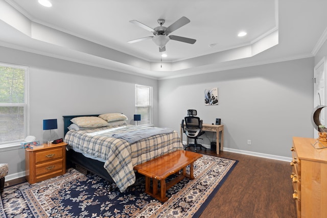 bedroom featuring crown molding, multiple windows, a raised ceiling, and dark wood finished floors