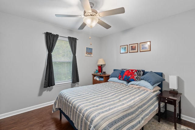 bedroom featuring wood finished floors, baseboards, and ceiling fan