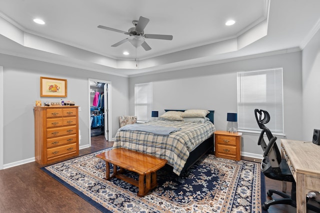 bedroom featuring baseboards, recessed lighting, ornamental molding, dark wood-type flooring, and a raised ceiling