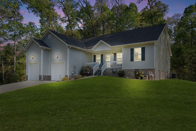 ranch-style house with cooling unit, driveway, a front yard, and covered porch