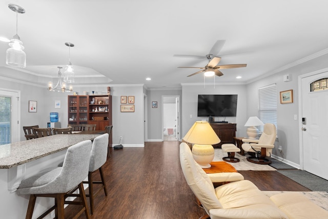 living area with recessed lighting, crown molding, baseboards, dark wood-style flooring, and ceiling fan with notable chandelier
