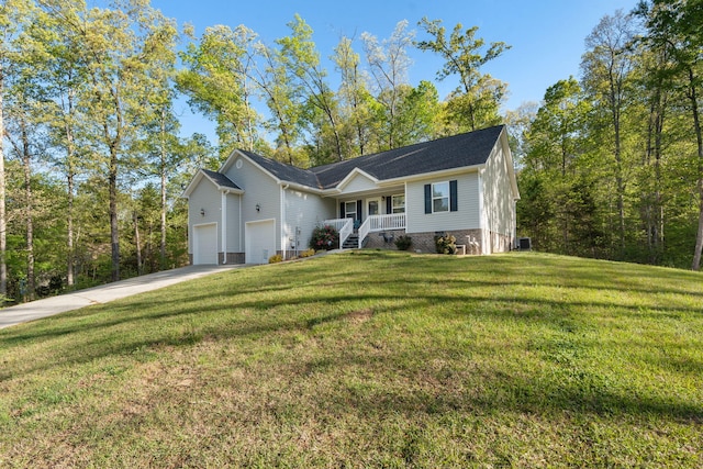 ranch-style house featuring a porch, an attached garage, a front lawn, and concrete driveway
