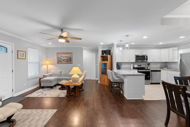 living area featuring recessed lighting, wood finished floors, and ceiling fan