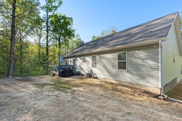 back of house featuring a fire pit, a wooden deck, and crawl space