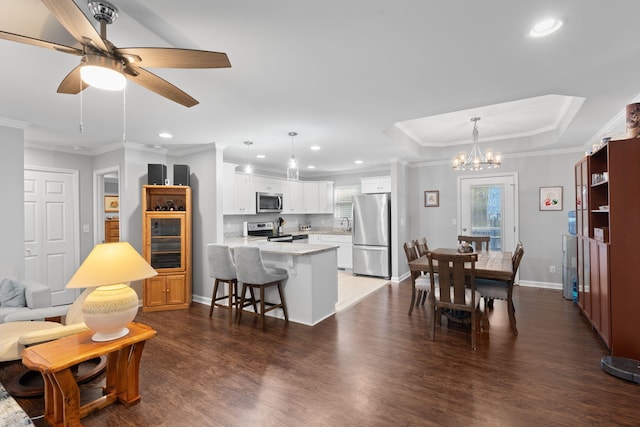 living room featuring dark wood finished floors, baseboards, crown molding, and recessed lighting