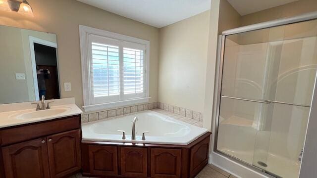 full bath featuring a stall shower, vanity, and a bath