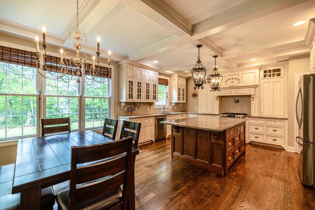 2734 Kensington Park Trl NW, Cleveland, TN 37312 - kitchen featuring a chandelier, appliances with stainless steel finishes, ornamental molding, light stone counters, and glass insert cabinets