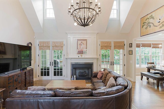 2734 Kensington Park Trl NW, Cleveland, TN 37312 - living area with french doors, high vaulted ceiling, a chandelier, wood finished floors, and plenty of natural light