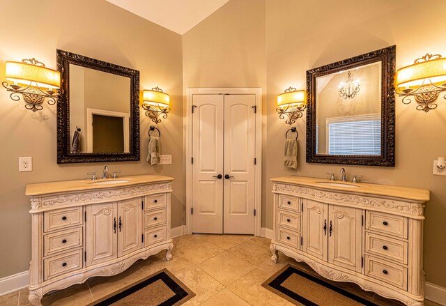 2734 Kensington Park Trl NW, Cleveland, TN 37312 - bathroom with two vanities, lofted ceiling, baseboards, and tile patterned flooring