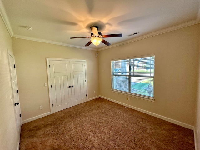 unfurnished bedroom featuring carpet flooring, ceiling fan, and ornamental molding