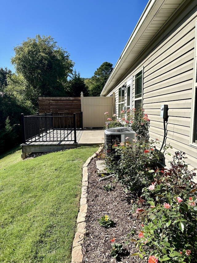 view of yard with cooling unit and a patio