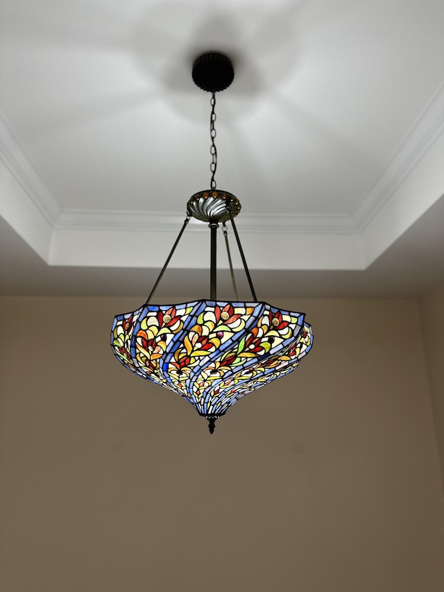 details with a raised ceiling and crown molding