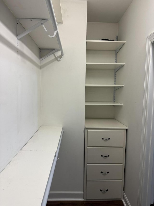 walk in closet featuring dark hardwood / wood-style flooring