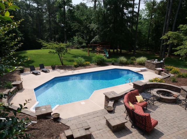 3611 Sourwood Trl NW, Cleveland, TN 37312 - swimming pool featuring an outdoor fire pit, a diving board, a yard, and a patio area