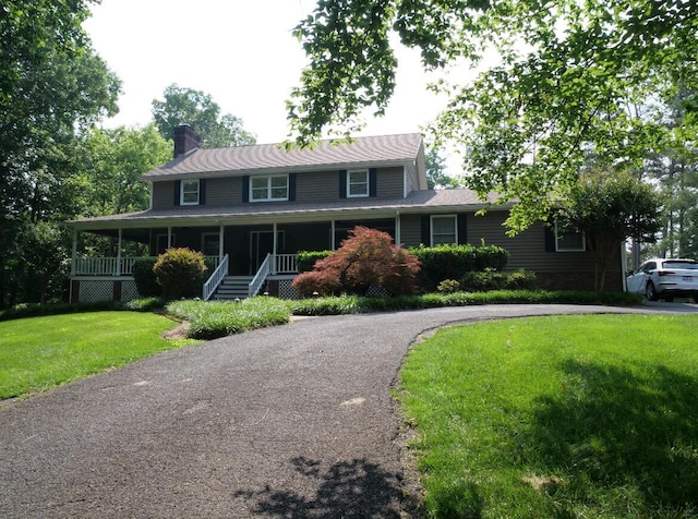 3611 Sourwood Trl NW, Cleveland, TN 37312 - farmhouse inspired home featuring a chimney, a front lawn, asphalt driveway, and covered porch