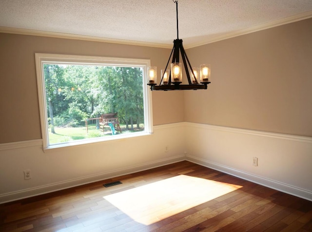 3611 Sourwood Trl NW, Cleveland, TN 37312 - spare room with a chandelier, a textured ceiling, hardwood / wood-style flooring, plenty of natural light, and crown molding