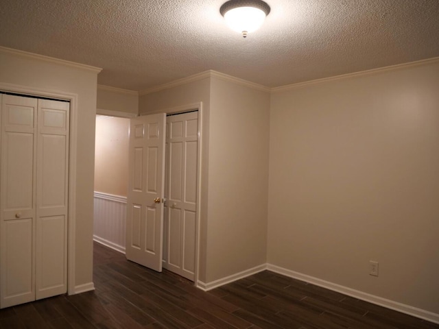 3611 Sourwood Trl NW, Cleveland, TN 37312 - unfurnished bedroom featuring dark wood-style flooring, a textured ceiling, ornamental molding, and baseboards