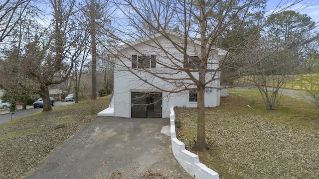 view of side of property with a garage and driveway