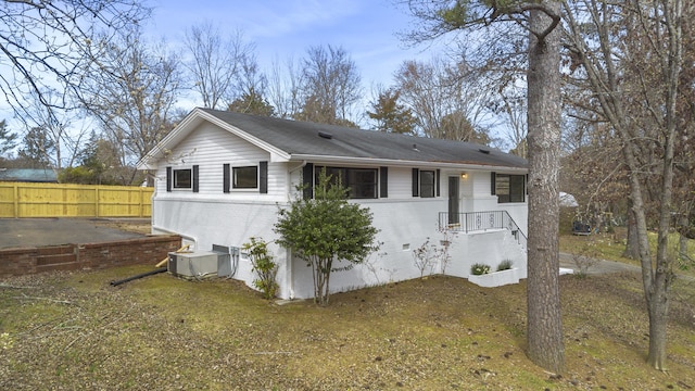 exterior space featuring fence, brick siding, central AC, and crawl space