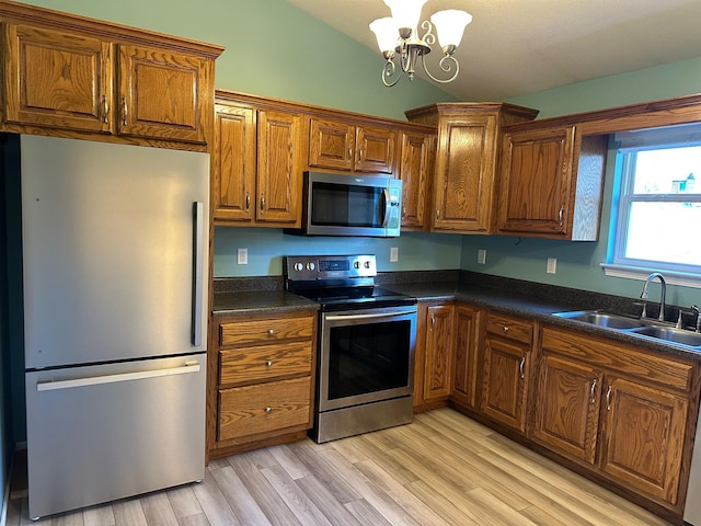 740 Grassy Branch Rd, Dayton, TN 37321 - kitchen featuring stainless steel appliances, vaulted ceiling, dark countertops, brown cabinetry, and a chandelier